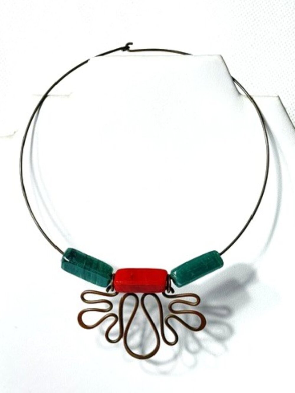 Brass choker with red and green stones.
